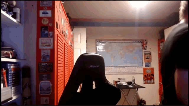 a room with a large map on the wall and a chair that says arozzi