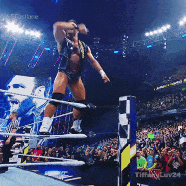 a man in a wrestling ring with tiffany luv24 on the bottom