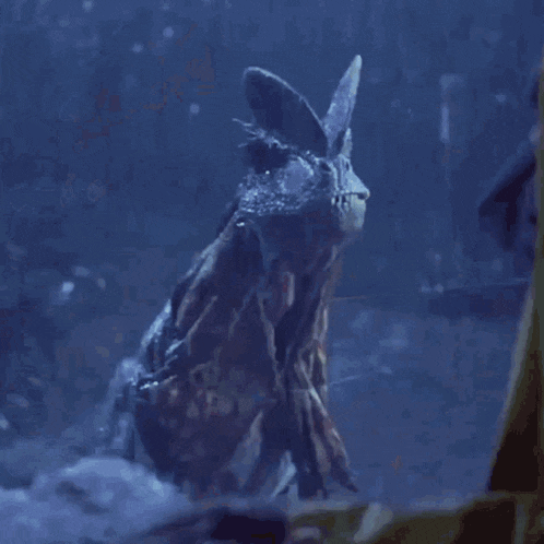 a close up of a monster with its mouth open in the dark .