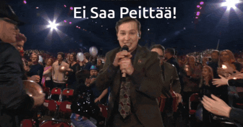 a man holding an accordion stands in front of a crowd with the words ei saa peittaa written on the bottom