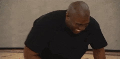 a man is doing push ups on a basketball court .