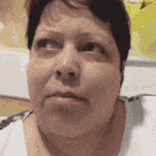 a close up of a woman 's face with a serious expression on her face .