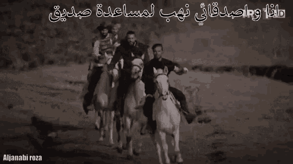a black and white photo of a group of men on horses