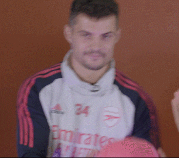 a blurry picture of a man wearing a emirates jersey