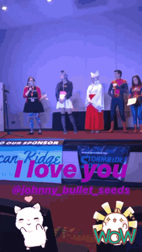 a group of people on a stage with a sign that says i love you