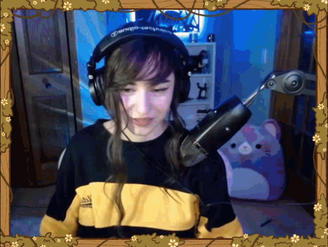 a girl wearing headphones and a shirt that says ' adidas ' on it