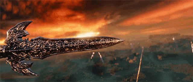a sword with a red sky in the background is being held by a person