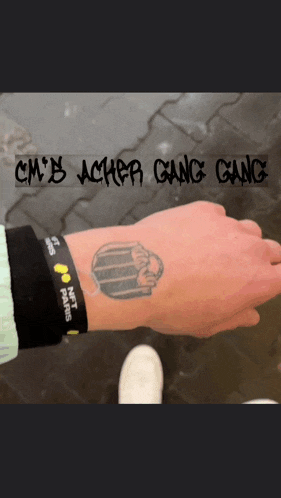 a person with a tattoo on their wrist that says cmb acher gang gang