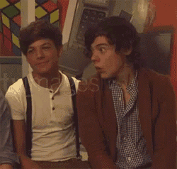two young men are sitting next to each other in front of a stained glass window