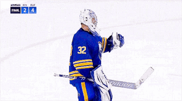 a hockey player with the number 32 on his jersey talks to another player