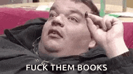 a fat man is laying on a bed with his hand on his forehead and says `` fuck them books '' .