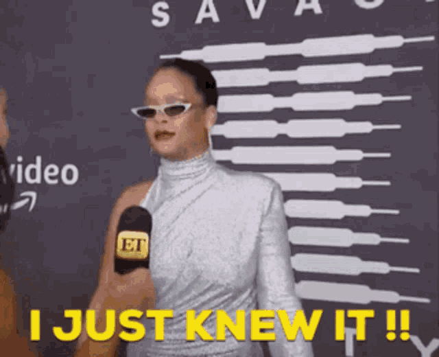 a woman wearing sunglasses is talking into a microphone and says " i just knew it !! "
