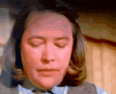 a woman with her eyes closed looks at the camera