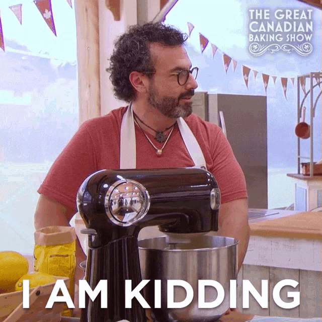 a man standing next to a mixer with the words " i am kidding " on the bottom