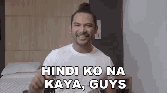 a man in a white shirt with the words hindi ko na kaya guys on it