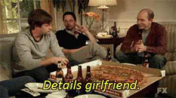 a group of men are sitting around a table with a box of pizza that says details girlfriend