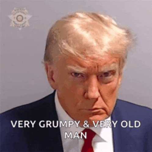 a very grumpy and very old man is wearing a suit and tie .