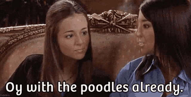 two women are sitting next to each other on a couch and one of them is talking to the other .