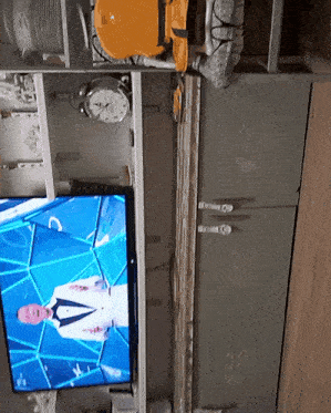 a tv shows a man in a suit and tie on a blue background