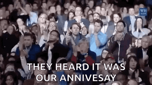 a crowd of people are applauding in a stadium and they heard it was our annivesay .