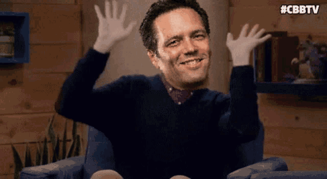 a man is sitting in a chair with his hands in the air and the hashtag #cbbtv on the bottom