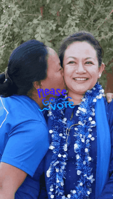 a woman is kissing another woman on the cheek with the words please vote written on the bottom