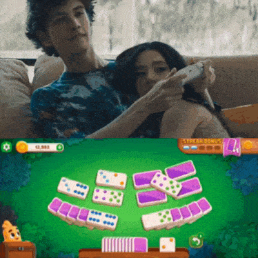 a man and woman are playing a game of dominoes with a streak bonus of 12,993