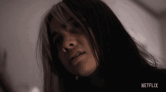 a close up of a woman 's face with netflix written on the bottom right