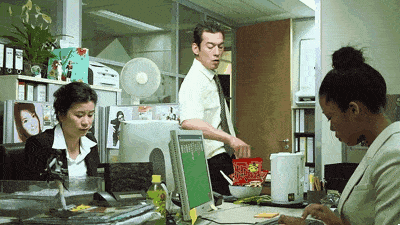 a man is standing in front of a computer with a green screen