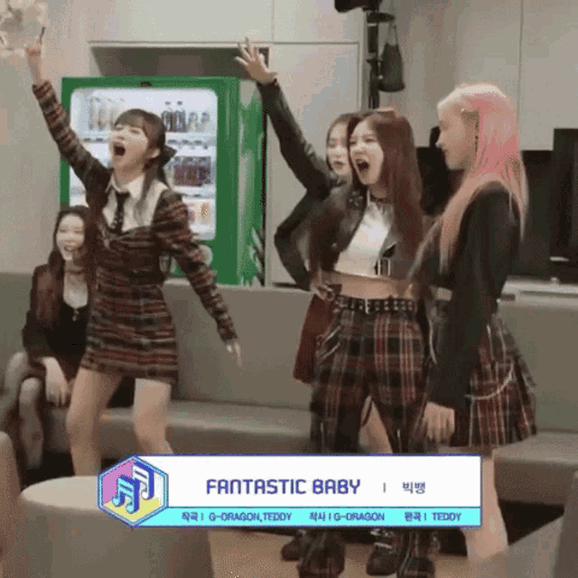 a group of girls are standing in front of a green vending machine with fantastic baby written on it