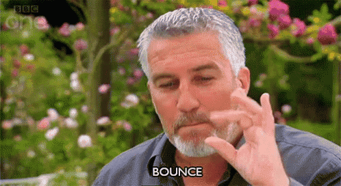 a man with a beard is making a bounce gesture with his hand