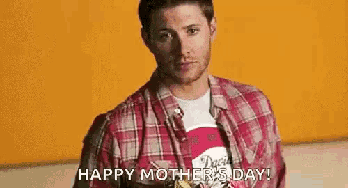 a man is holding a bouquet of flowers in front of his face and says `` happy mother 's day ! ''
