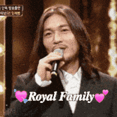 a man in a suit is singing into a microphone with the words royal family written above him