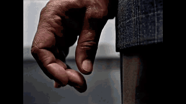 a close up of a person 's hand reaching out to touch something