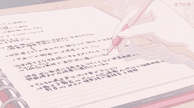 someone is writing in a notebook with a pink pencil