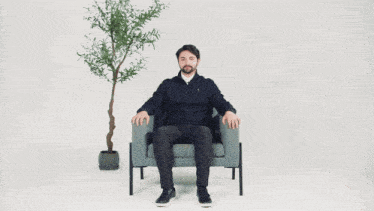a man sitting in front of a plant with the words " the impact " written below him
