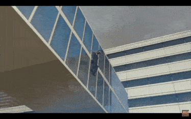 a video of a man climbing a building with the words spiderman on the bottom left