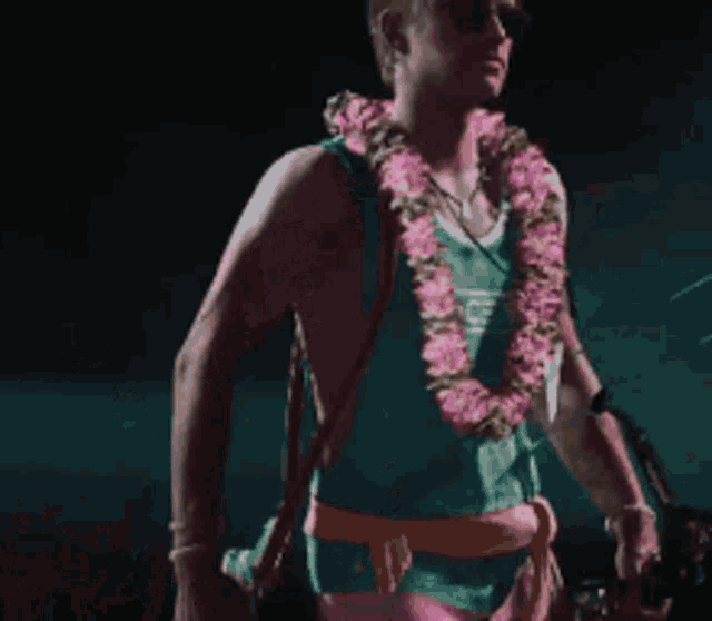 a man wearing a green tank top with the word edge on it