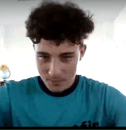 a young man with curly hair is wearing a blue shirt with the word fin on it