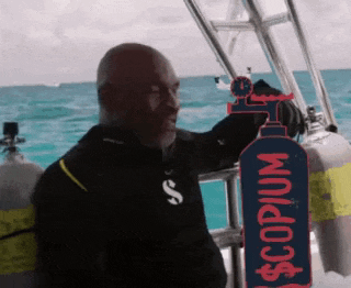 a man stands on a boat holding a sign that says copium
