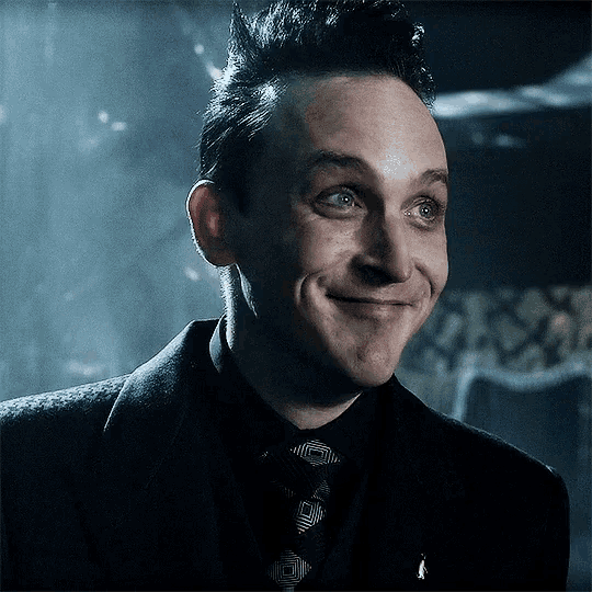 a man in a suit and tie is smiling