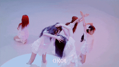 a group of girls are dancing with the word choom on the bottom