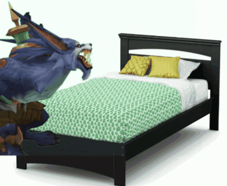 a bed with a green blanket and yellow pillows and a monster on it