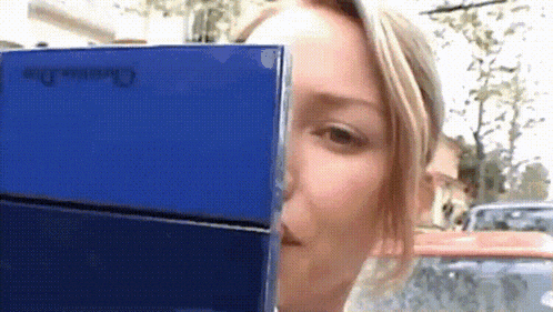 a woman is looking at a blue box that says christian dior