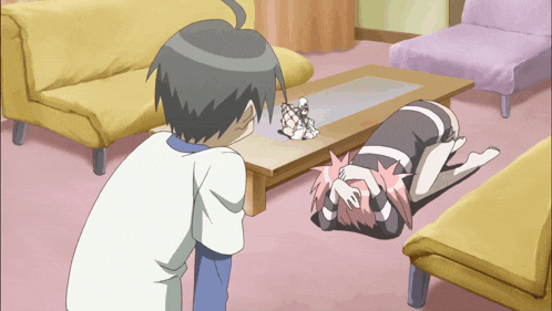 a boy and a girl are in a living room looking at a statue on a table