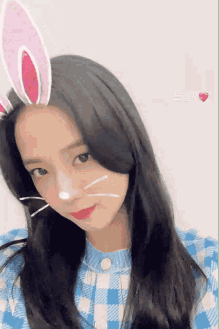a woman wearing bunny ears and a plaid shirt