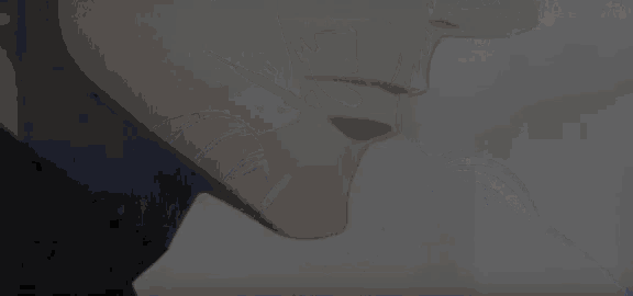 a close up of a man 's face with a black shirt on