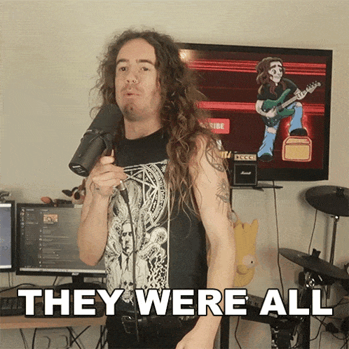 a man with long hair is holding a microphone in front of a screen that says they were all