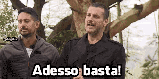 two men standing next to each other with the words adesso basta written on the bottom