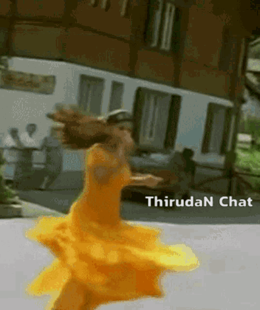 a blurred image of a woman in a yellow dress with thirudan chat written on the bottom